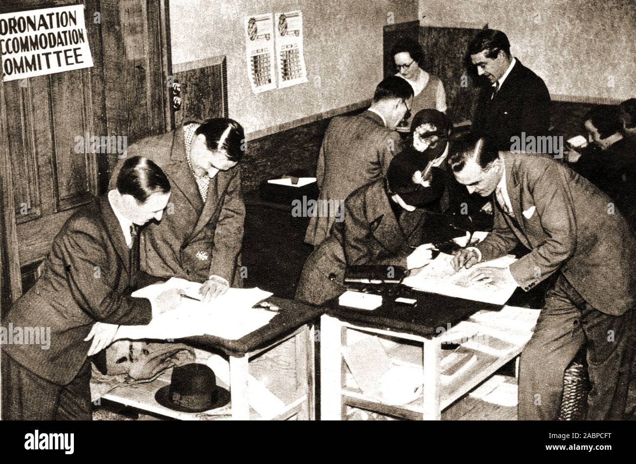 1937 photo - Staff making preparations for the UK Coronation  of George VI and Elizabeth .Coronation Accommodation Committee  activity in the branch office at Charing Cross Hotel, London Stock Photo