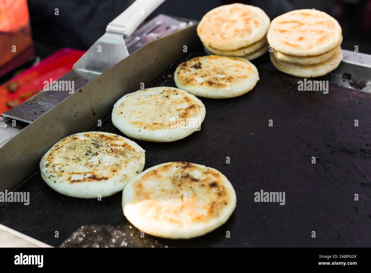 Arepas, Colombian corn patties filled with cheese, at a street food