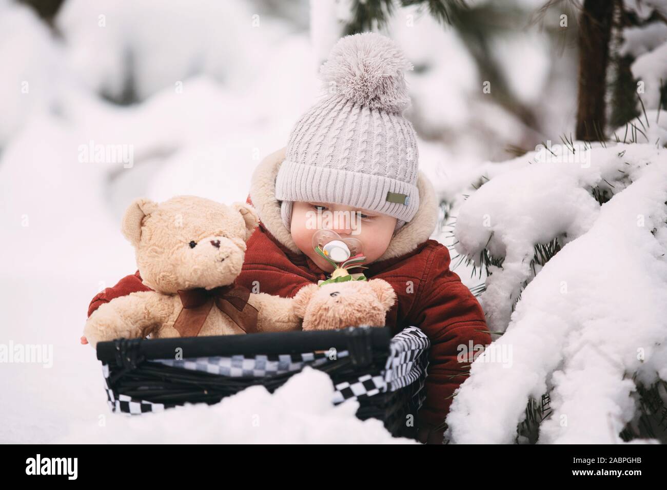cute little baby boy with teddy bears in winter forest Stock Photo - Alamy