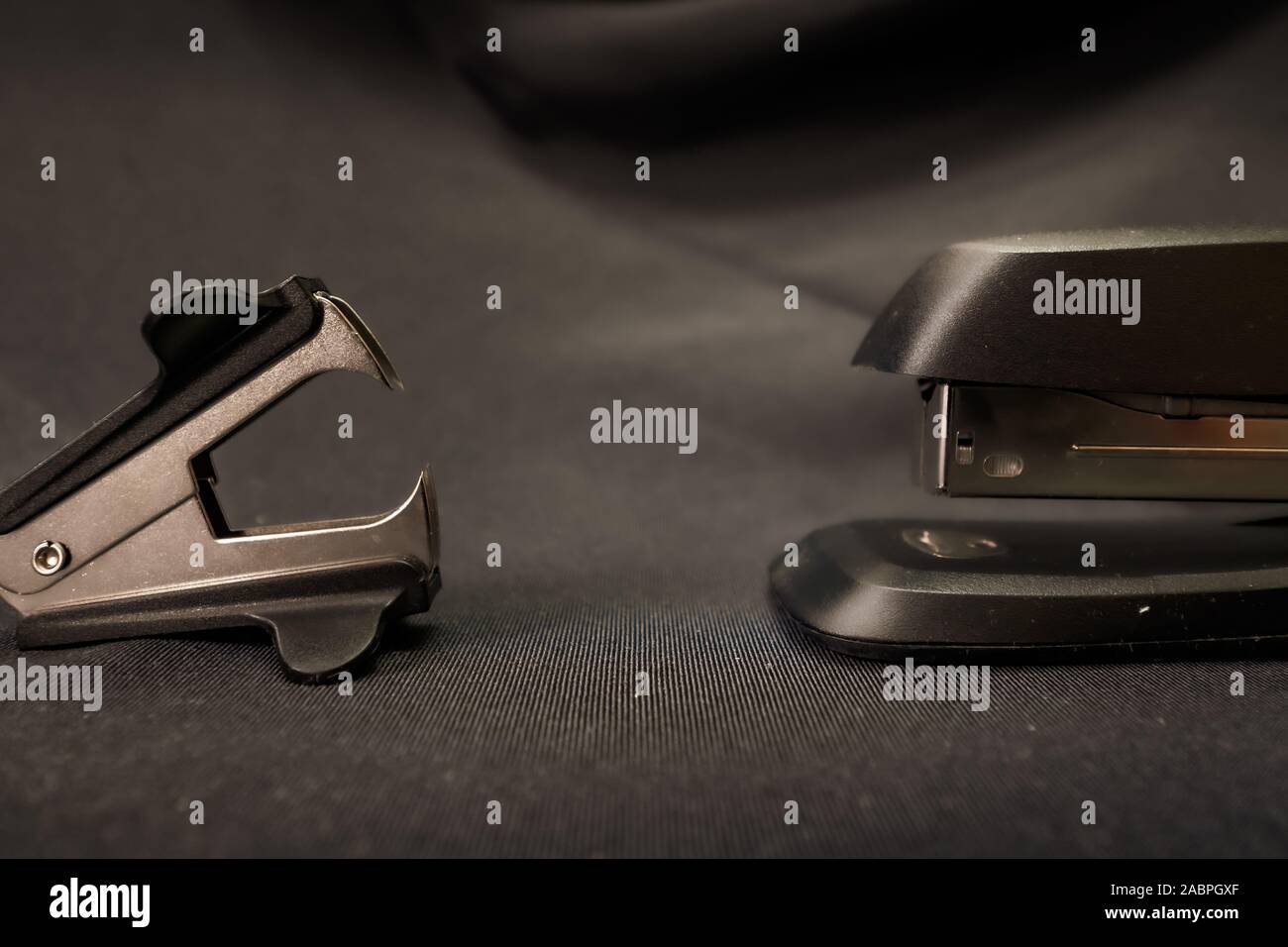 Stapler verses staple remover Office conflict example Stock Photo