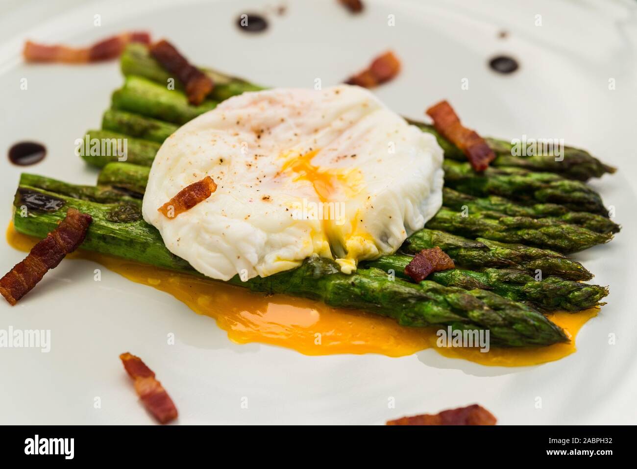 Food photography of a poached egg with asparagus, and crispy bacon