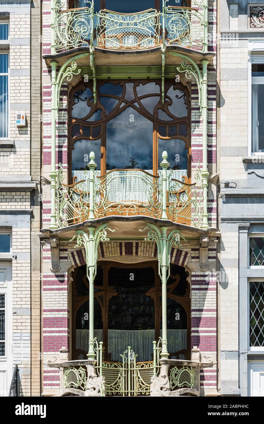 Brussels/ Belgium - 07 03 2019; Typical art nouveau facade with shaped metal ornaments, round windows, arches and decorated curling stairs at Square M Stock Photo