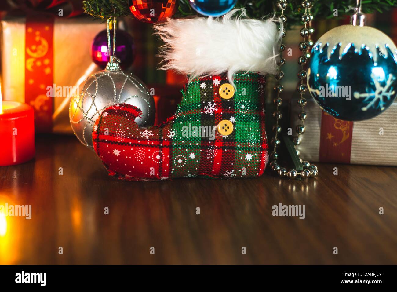 Christmas decorations and ornaments under a Christmas tree around the holidays. Festive celebration. Stock Photo
