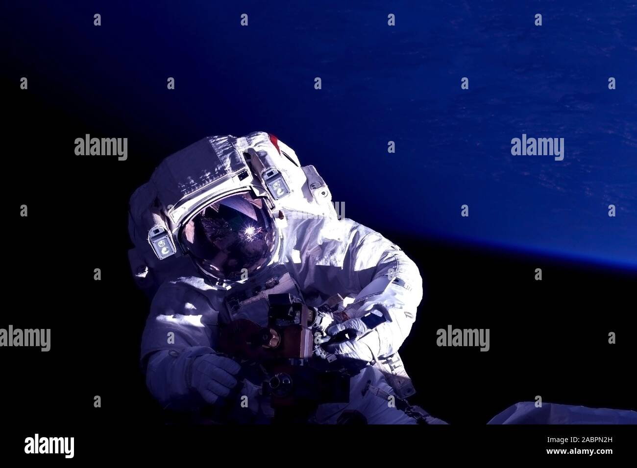 Astronaut at the space station is engaged in repairs. Elements of this image were furnished by NASA. Stock Photo