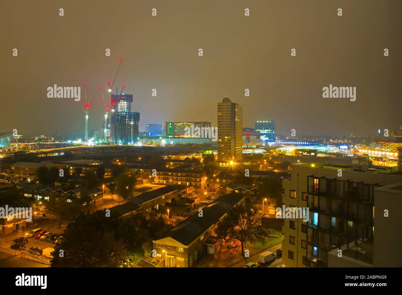 A view across Stratford, London with Westfield Shopping centre illuminated in the background. Stock Photo