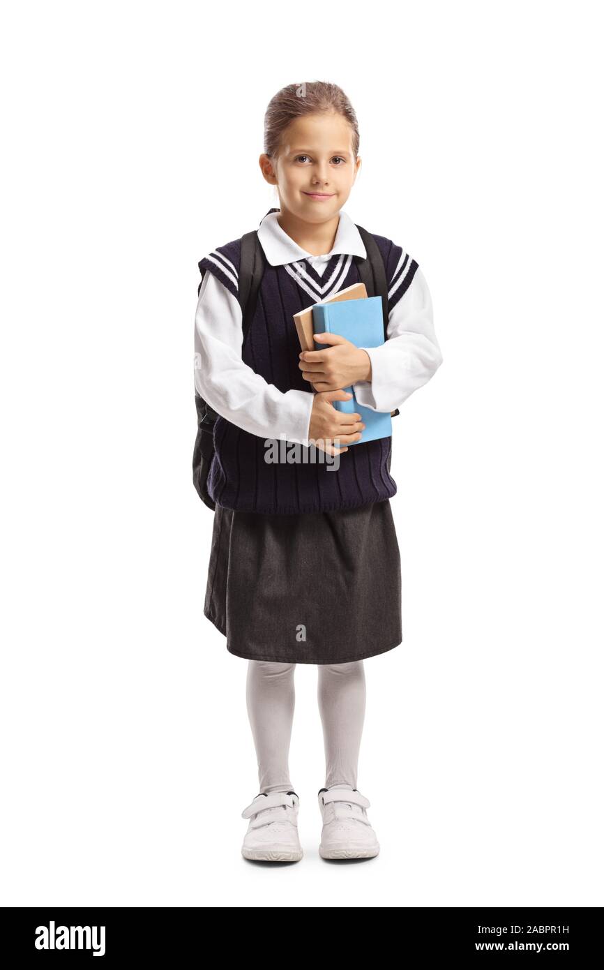 Full length portrait of a little schoolgirl holding books and posing ...