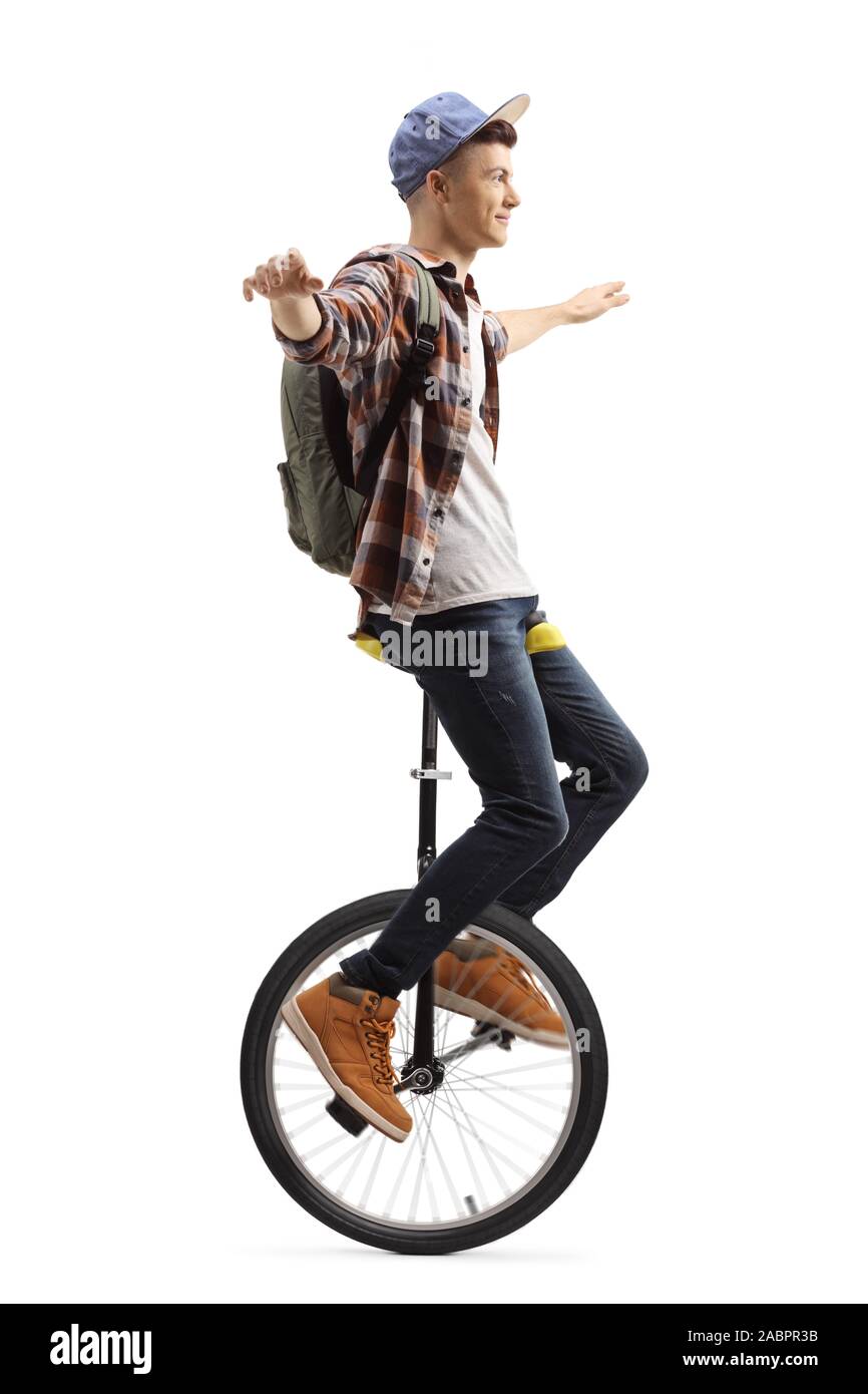 Full length shot of a male student riding a unicycle isolated on white background Stock Photo