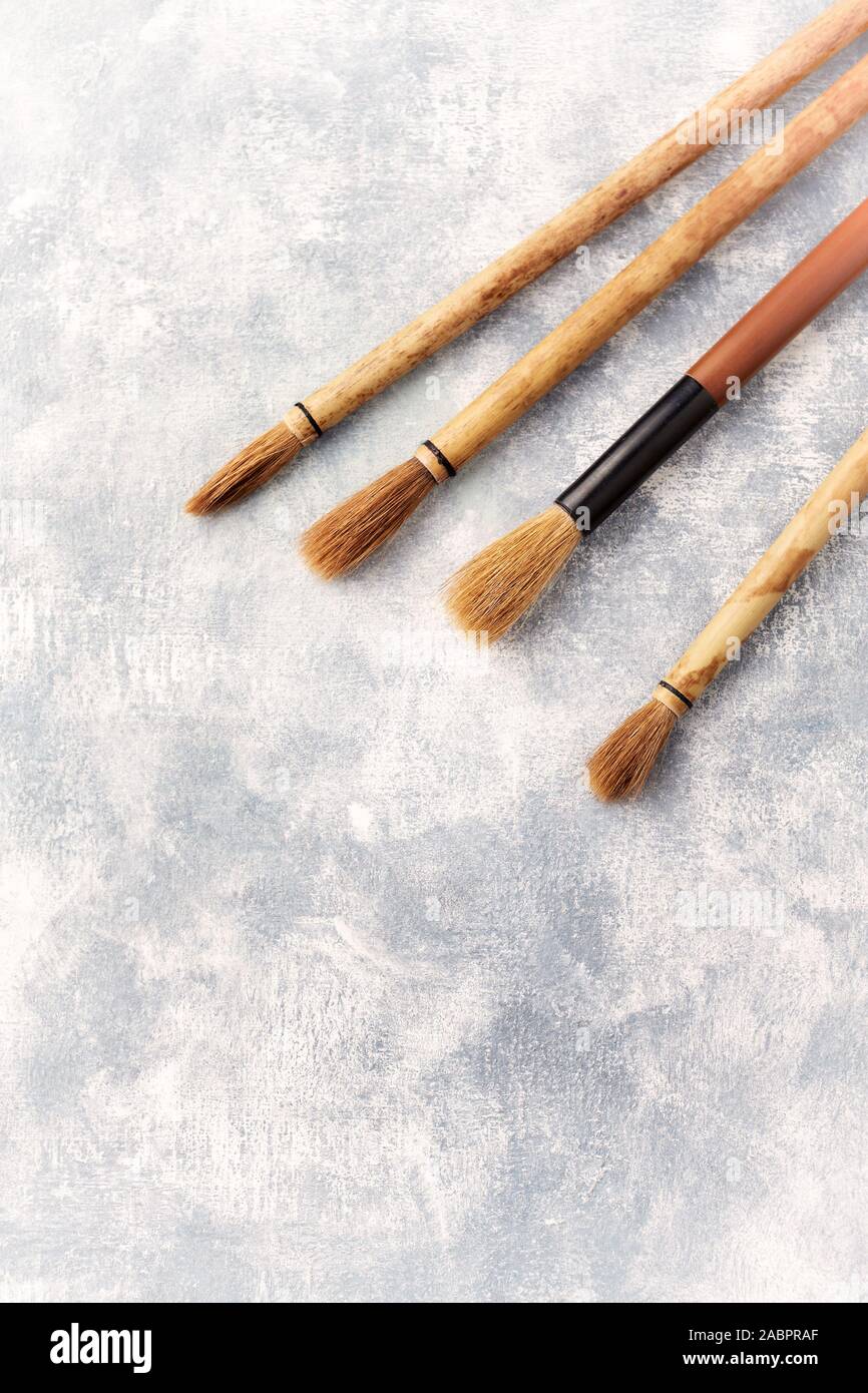 Set of brushes Fude for Sumie painting. Bright wooden background. Top view. Copy space Stock