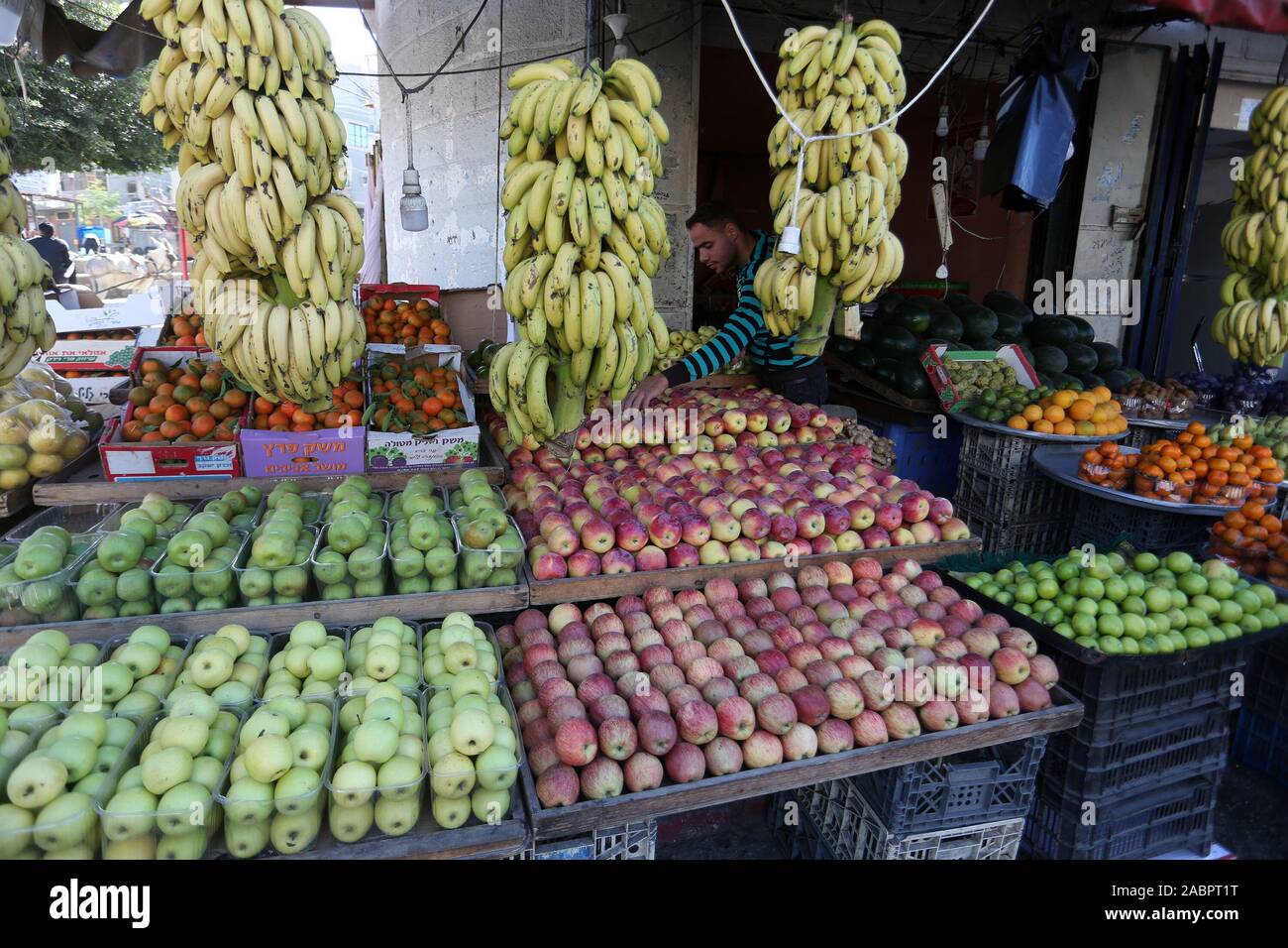 A young Palestinian sells in the market in Khan Younis, southern Gaza Strip, on November 28, 2019. Photo by Abed Rahim Khatib/Alamy Stock Photo