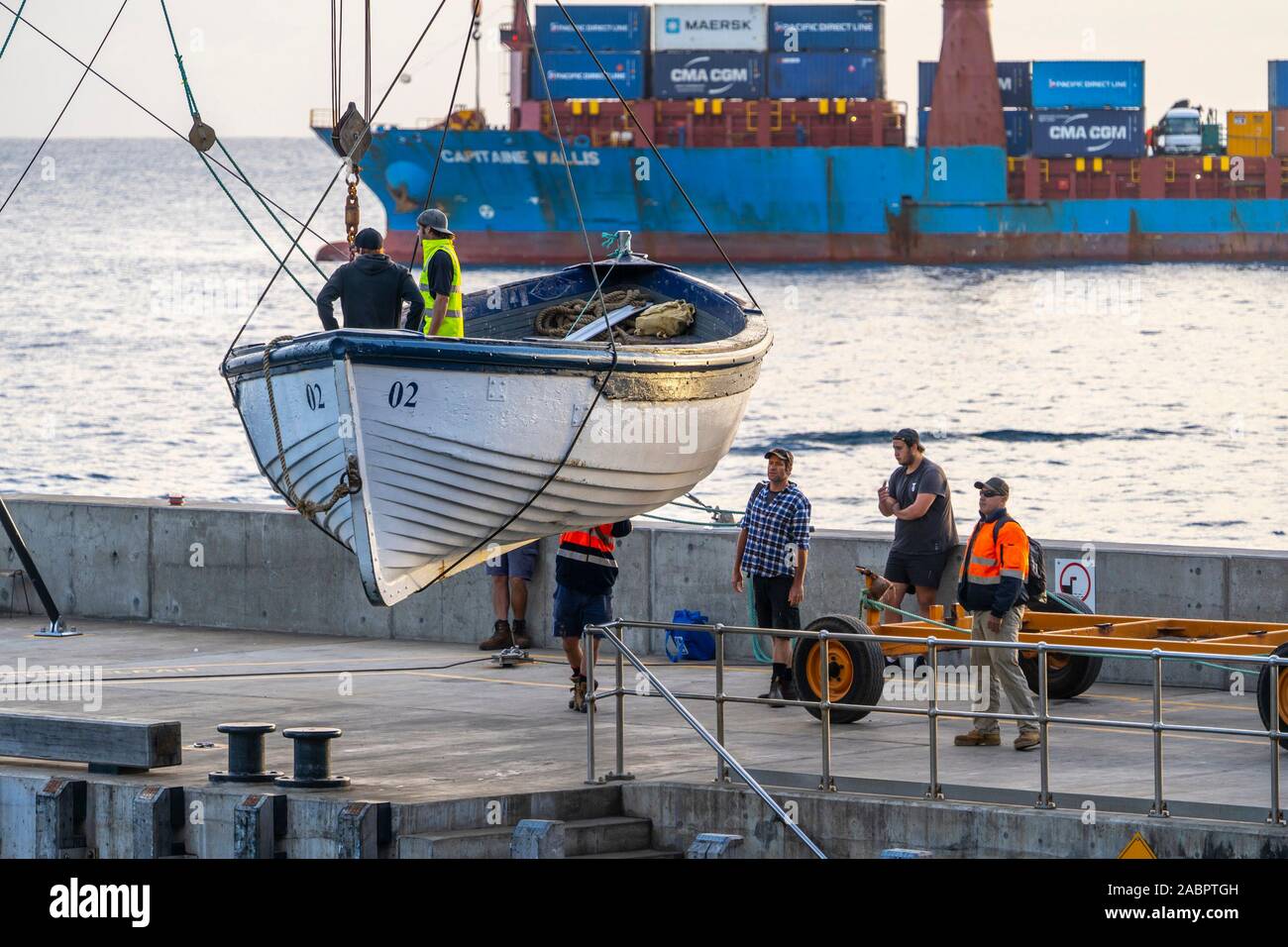 Lighter being launched in Cascade Bay for offloading supplies brought by ship. Norfolk Island, Australia Stock Photo