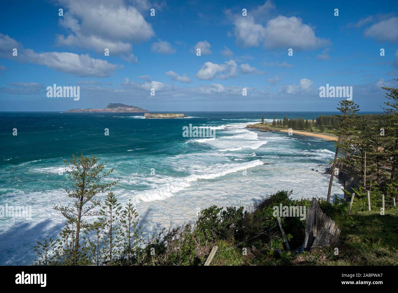 Cemetery Bay with Phillip Island seven km off the coast. The 190-hectare island is part of Norfolk Island National Park. Landing entails jumping from Stock Photo