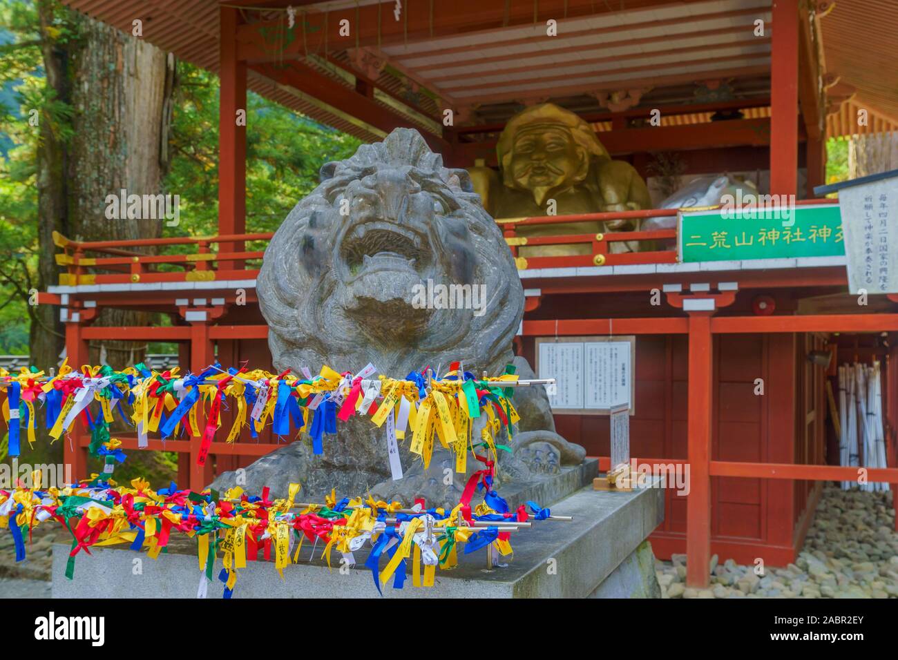 Nikko, Japan - September 29, 2019: View of lion statue with blessing notes, in Futarasan jinja shrine, Nikko, Japan Stock Photo
