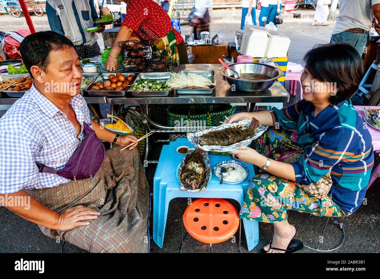 A Couple Eating A Fish Meal From A Street Food Stall, Yangon, Myanmar. Stock Photo
