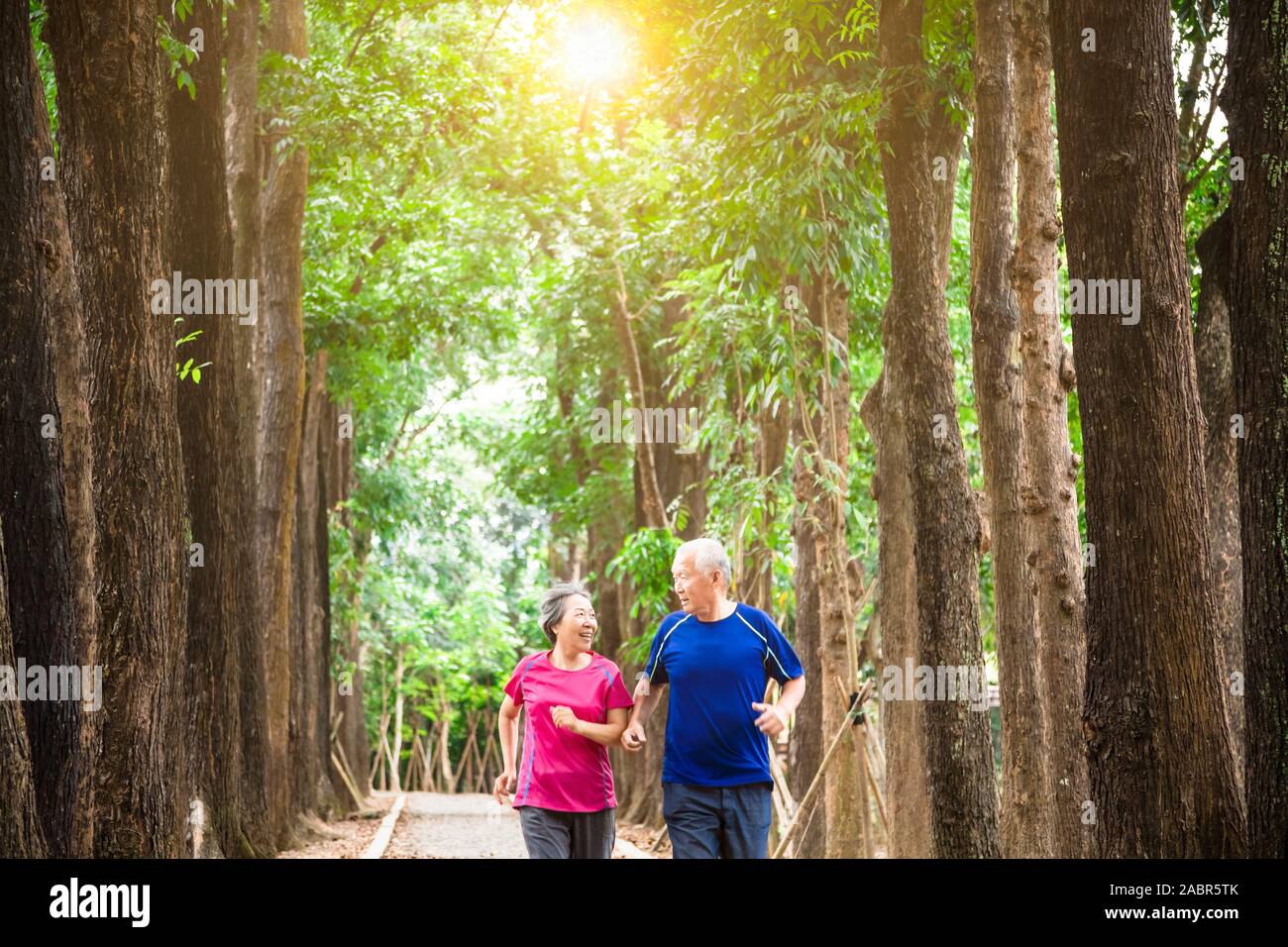 happy asian senior couple jogging together at morning Stock Photo - Alamy