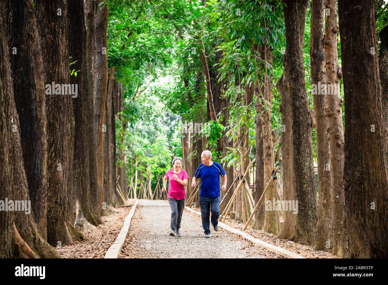 happy asian senior couple jogging together at morning Stock Photo - Alamy