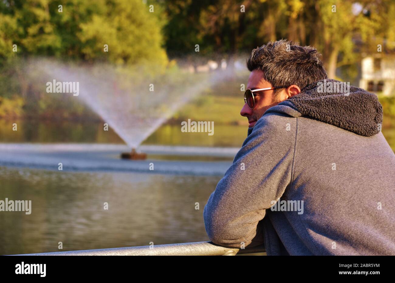 Resting On Railing Man Resting on Railing Looking out at Fountain Stock Photo - Alamy