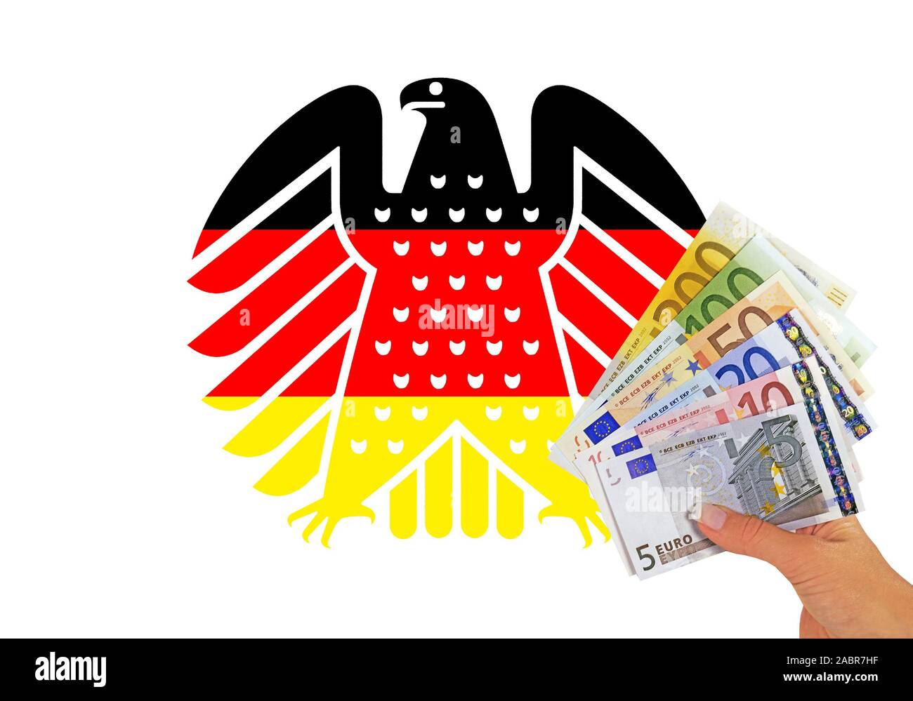 Neuer Bundesadler in den Farben schwarz-rot-gold, Wappentier der Bundesrepublik Deutschland, davor Hand mit Banknoten, Stock Photo