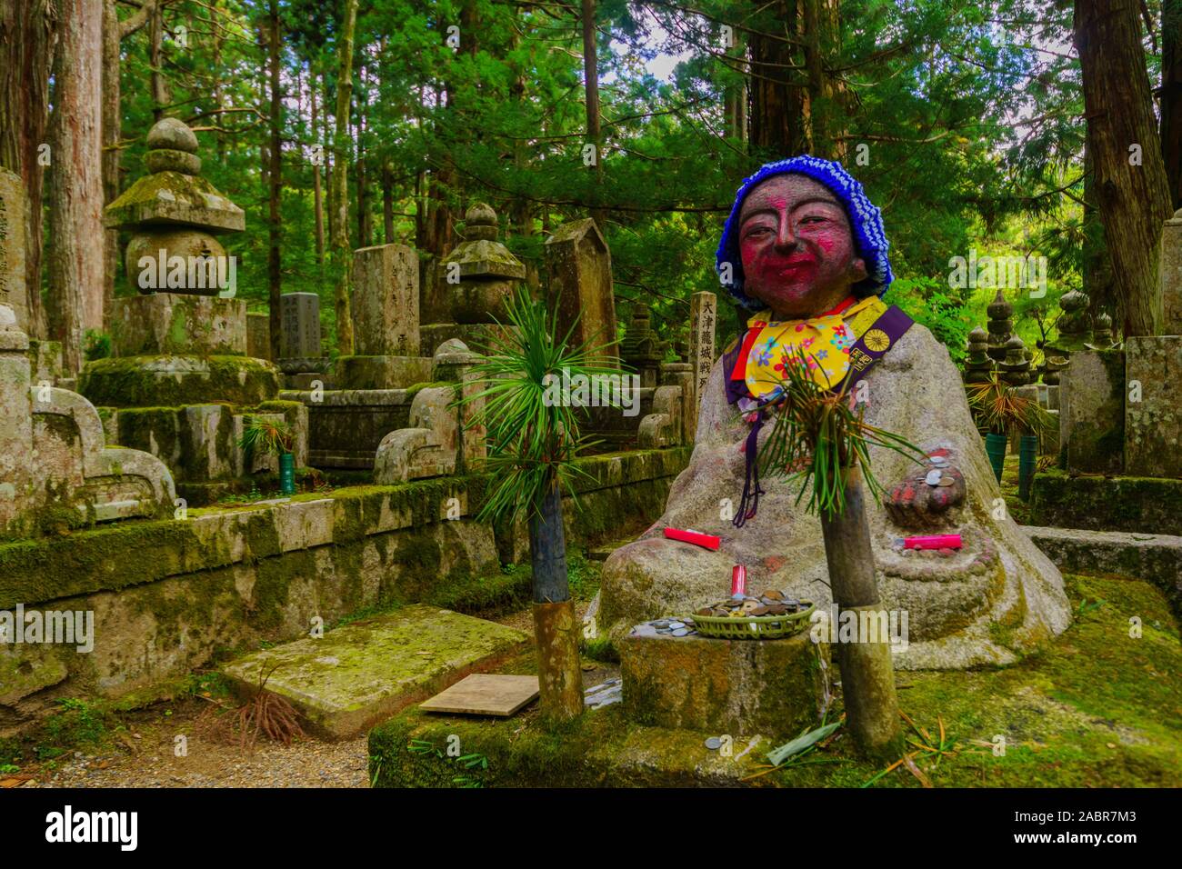 Koyasan, Japan - October 7, 2019: View of graves and Jizo (Japanese Bodhisattva statues dressed in a red cloth) in the Okunoin Cemetery, Mount Koya (K Stock Photo