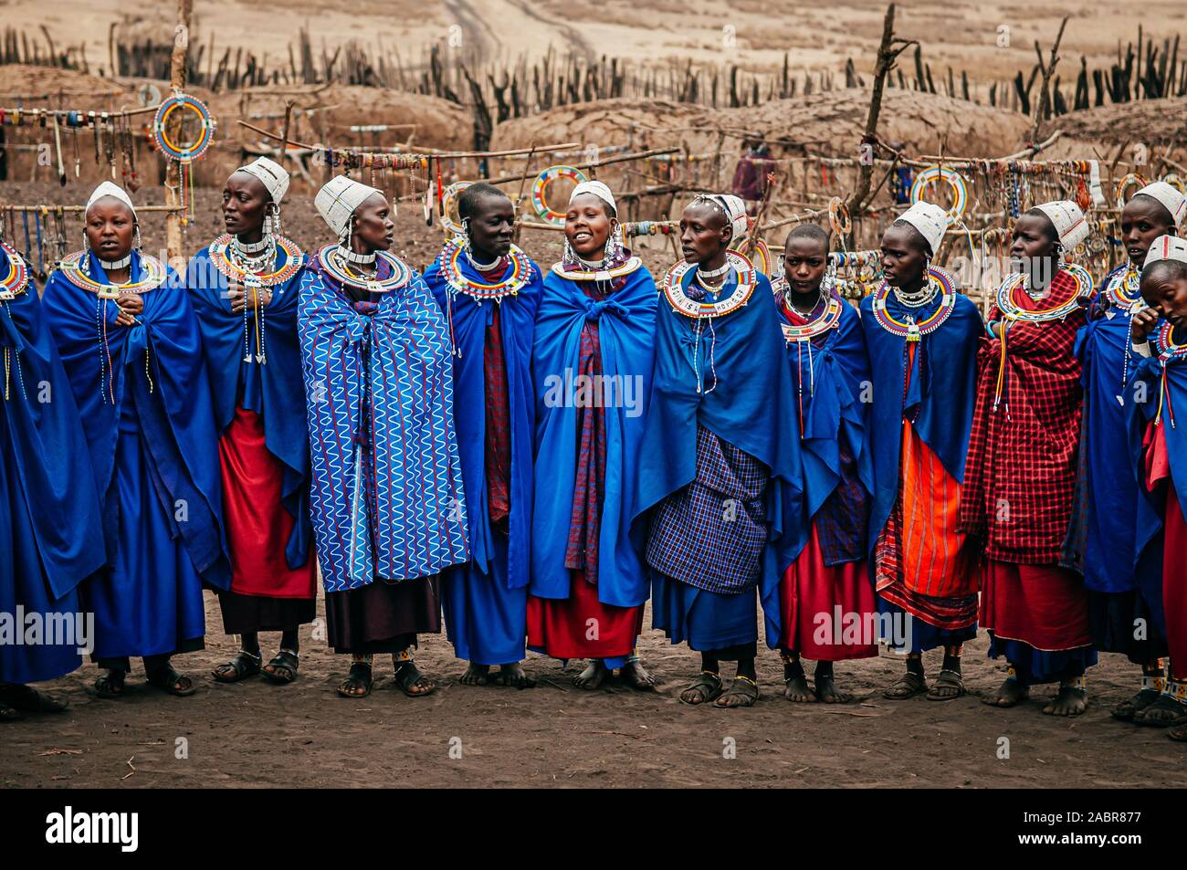 JUN 24, 2011 Serengeti, Tanzania - Group of African Masai or Maasai tribe woman in blue cloth wearing headpiece and stone beads ornaments. Ethnic grou Stock Photo