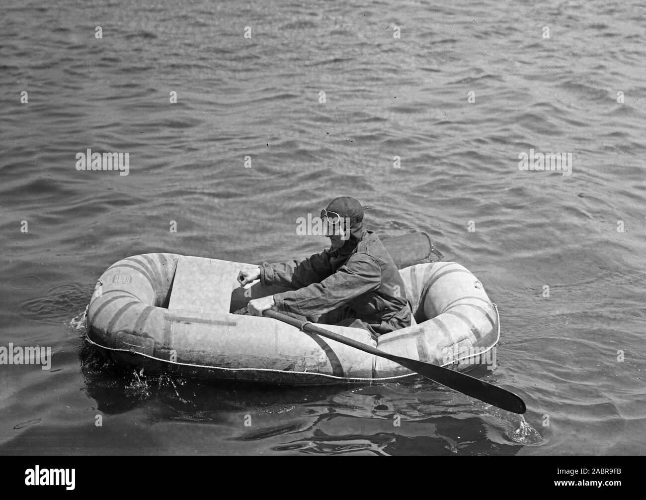 Man rowing inflatable boat ca. May 1925 Stock Photo