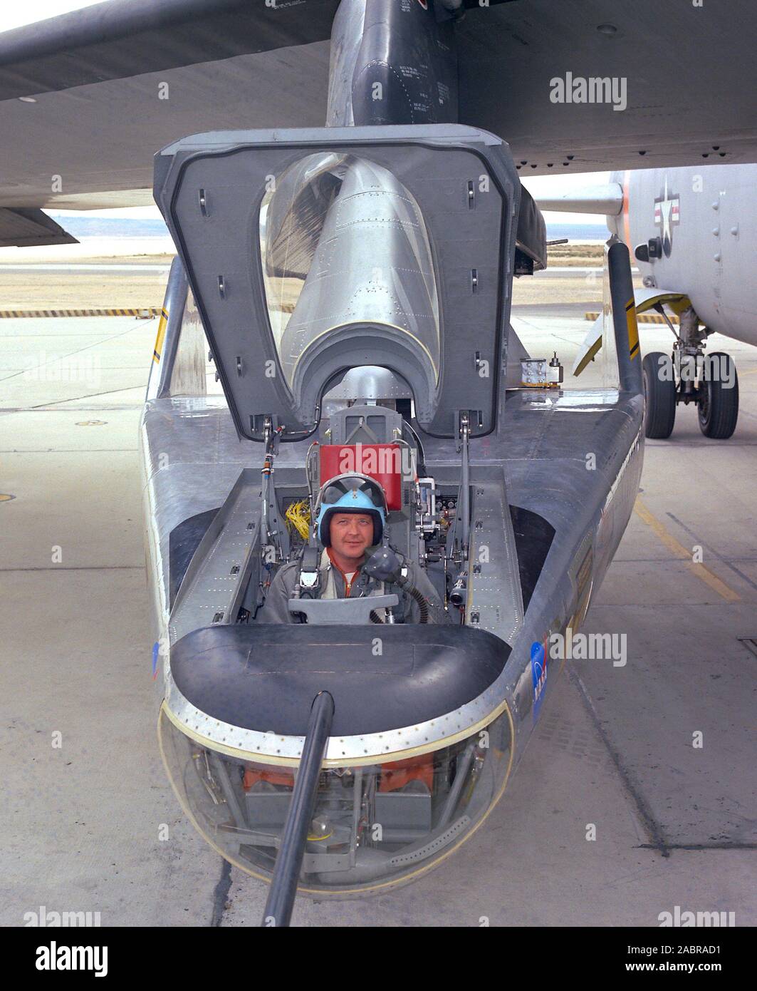 NASA research pilot Milt Thompson sits in the M2-F2 'heavyweight' lifting body research vehicle before a 1966 test flight. The M2-F2 and the other lifting-body designs were all attached to a wing pylon on NASA’s B-52 mothership and carried aloft. The vehicles were then drop-launched and, at the end of their flights, glided back to wheeled landings on the dry lake or runway at Edwards AFB. The lifting body designs influenced the design of the Space Shuttle and were also reincarnated in the design of the X-38 in the 1990s. Stock Photo