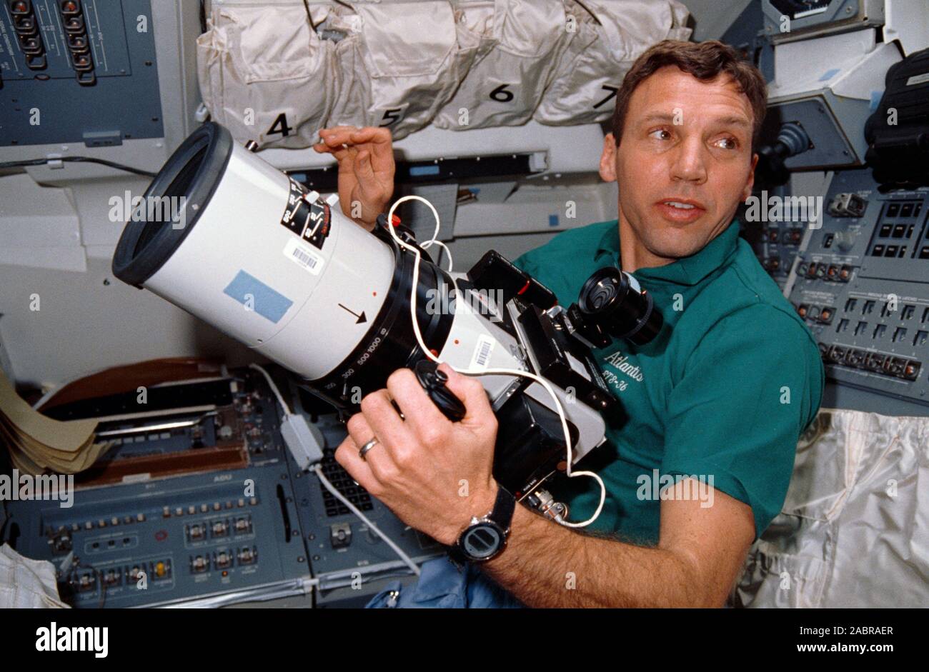 (28 Feb-3 March 1990) --- Astronaut David C. Hilmers, on the aft flight deck of the Earth-orbiting Atlantis, prepares to use the large-format Aero Linhof camera used for recording of Earth imagery. Hilmers and four other NASA astronauts spent four days, 10 hours and 19 minutes aboard the spacecraft for the DOD-devoted mission. Stock Photo