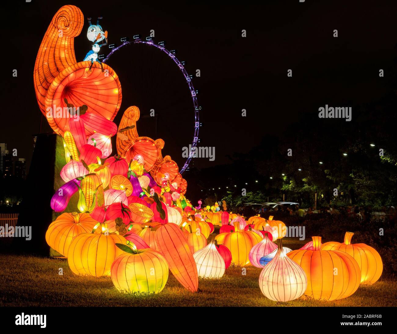 Lighted harvest lantern with Singapore Flyer as background. Stock Photo