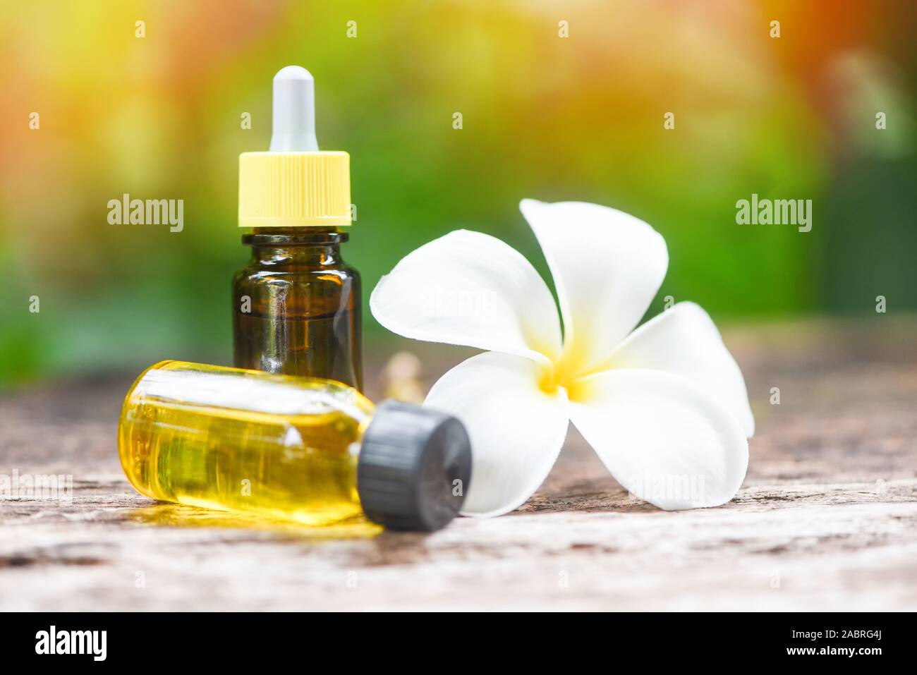 Aromatherapy herbal oil bottles aroma with white flower Frangipani  Plumeriaon with nature background / Essential oils natural on wooden table  and orga Stock Photo - Alamy