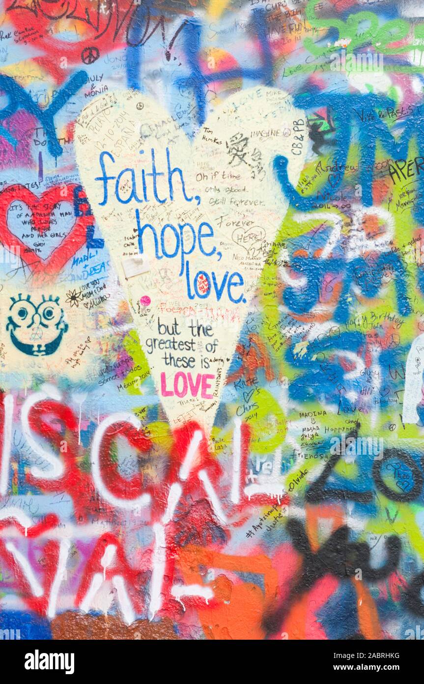Prague, Czech Republic - October 23, 2014 - 'Faith, hope, love' graffiti on the John Lennon wall. Stock Photo