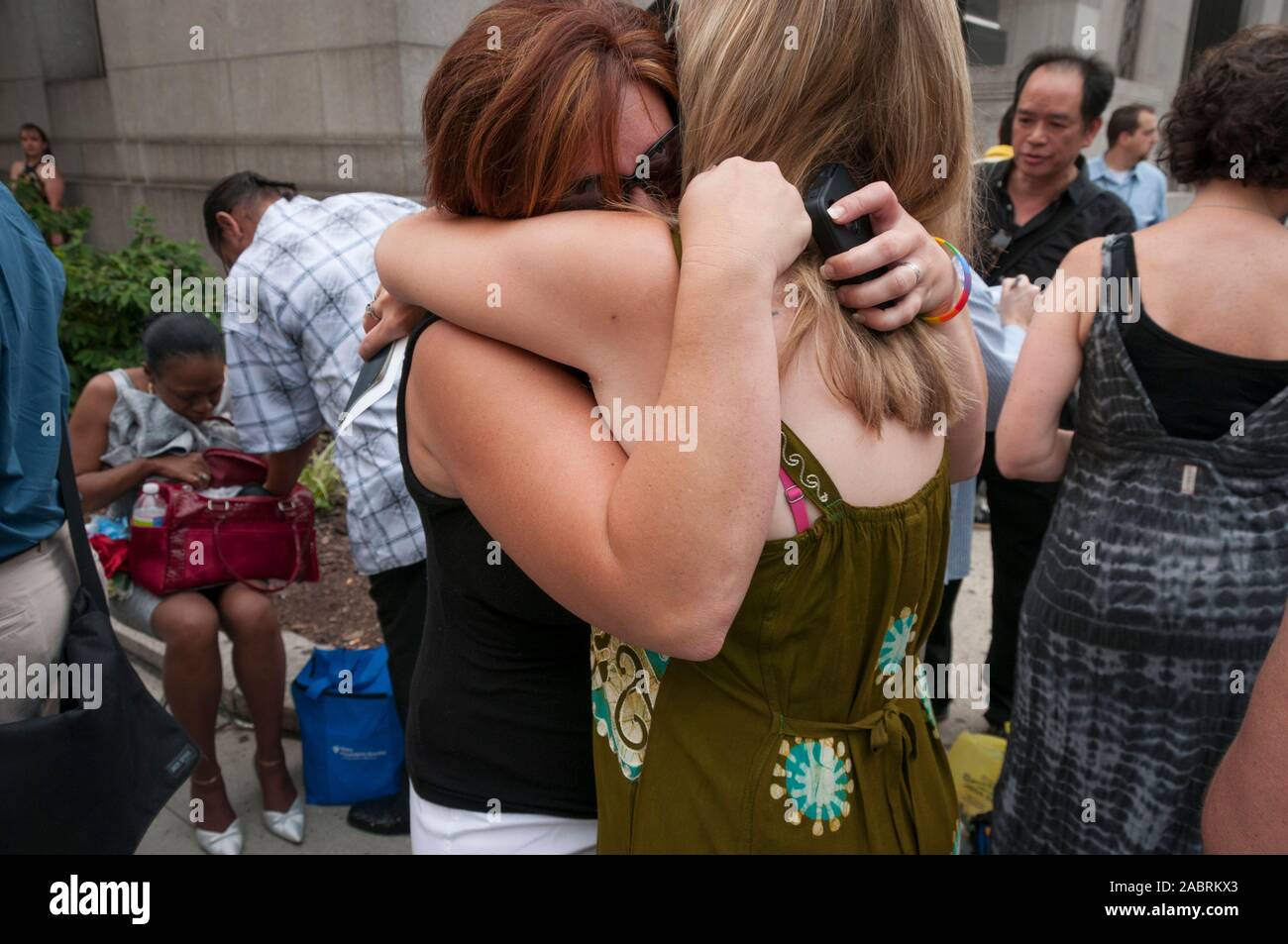 An emotional lesbian couple embraces outside the Manhattan City Clerk's office on the first day of legal same-sex marriage in New York State, USA. Stock Photo