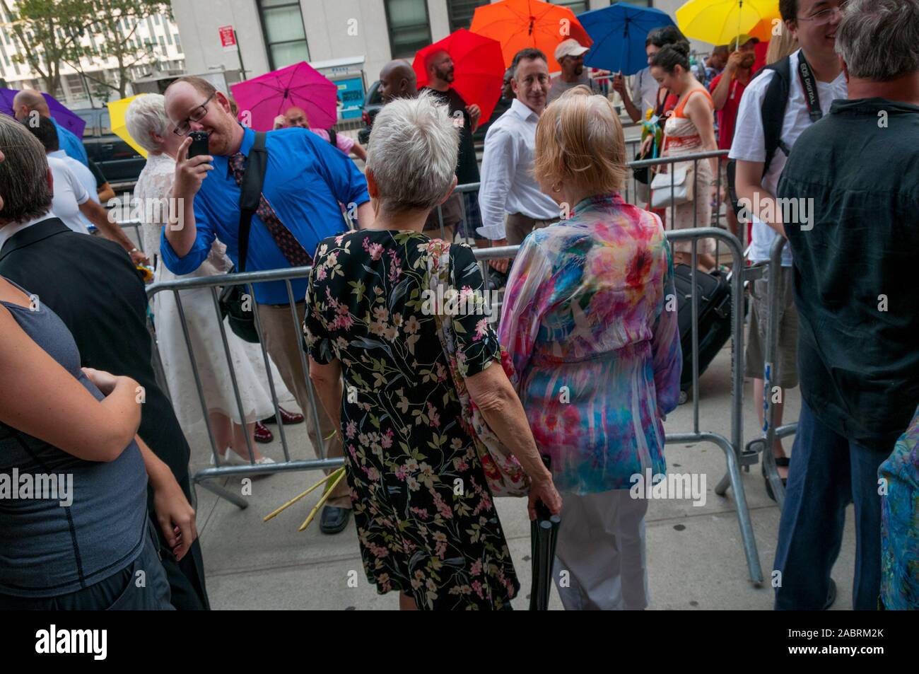 A lesbian couple waits in line outside the Manhattan City Clerk's office on the first day of legal same-sex marriage in New York State, USA. Stock Photo