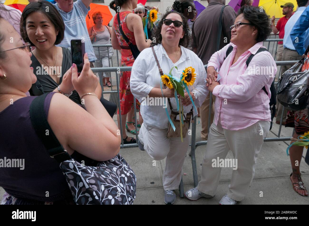 A lesbian couple waits in line outside the Manhattan City Clerk's office on the first day of legal same-sex marriage in New York State, USA. Stock Photo