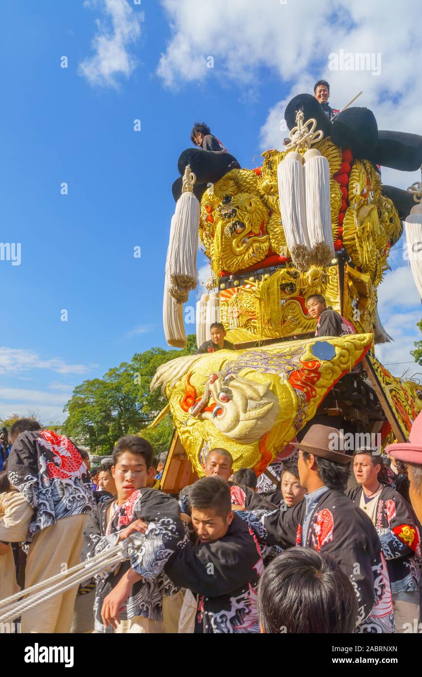 Saijo, Japan - October 16, 2019: Parade with participants carrying Mikoshi floats (portable shrines), in city center. Saijo Isono Shrine Festival, Ehi Stock Photo