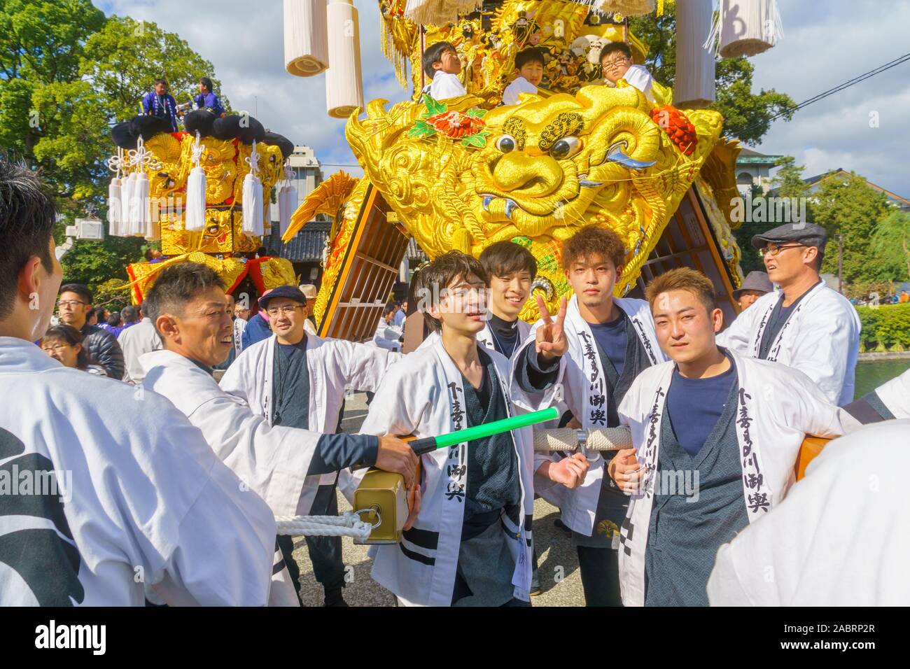Saijo, Japan - October 16, 2019: Parade with participants carrying Mikoshi floats (portable shrines), in city center. Saijo Isono Shrine Festival, Ehi Stock Photo