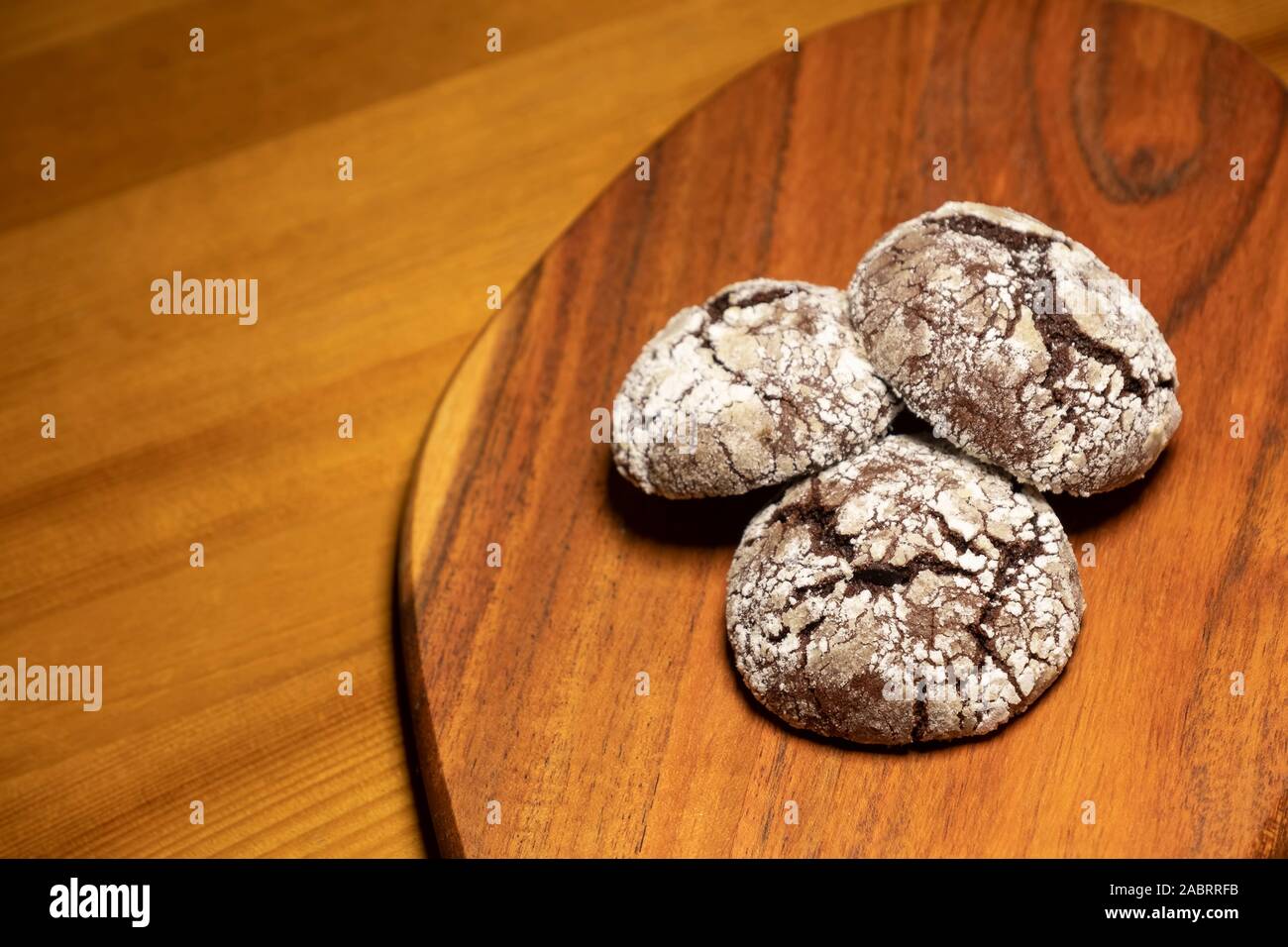 Cracked Chocolate Cookies On A Wooden Surface Stock Photo