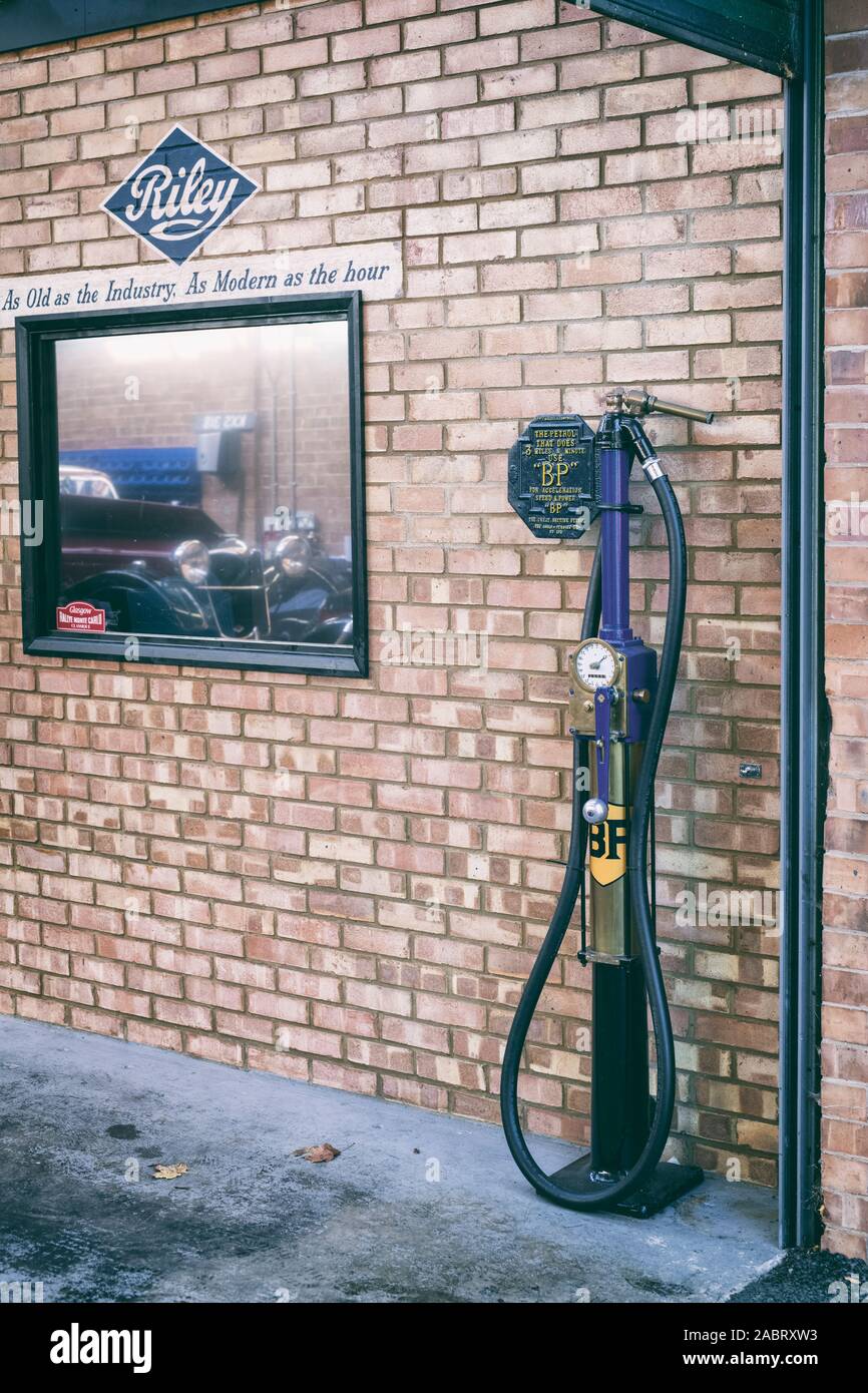 Vintage BP petrol pump in a workshop at Bicester Heritage Centre autumn Sunday Scramble event. Bicester, Oxfordshire, England. Vintage filter applied Stock Photo