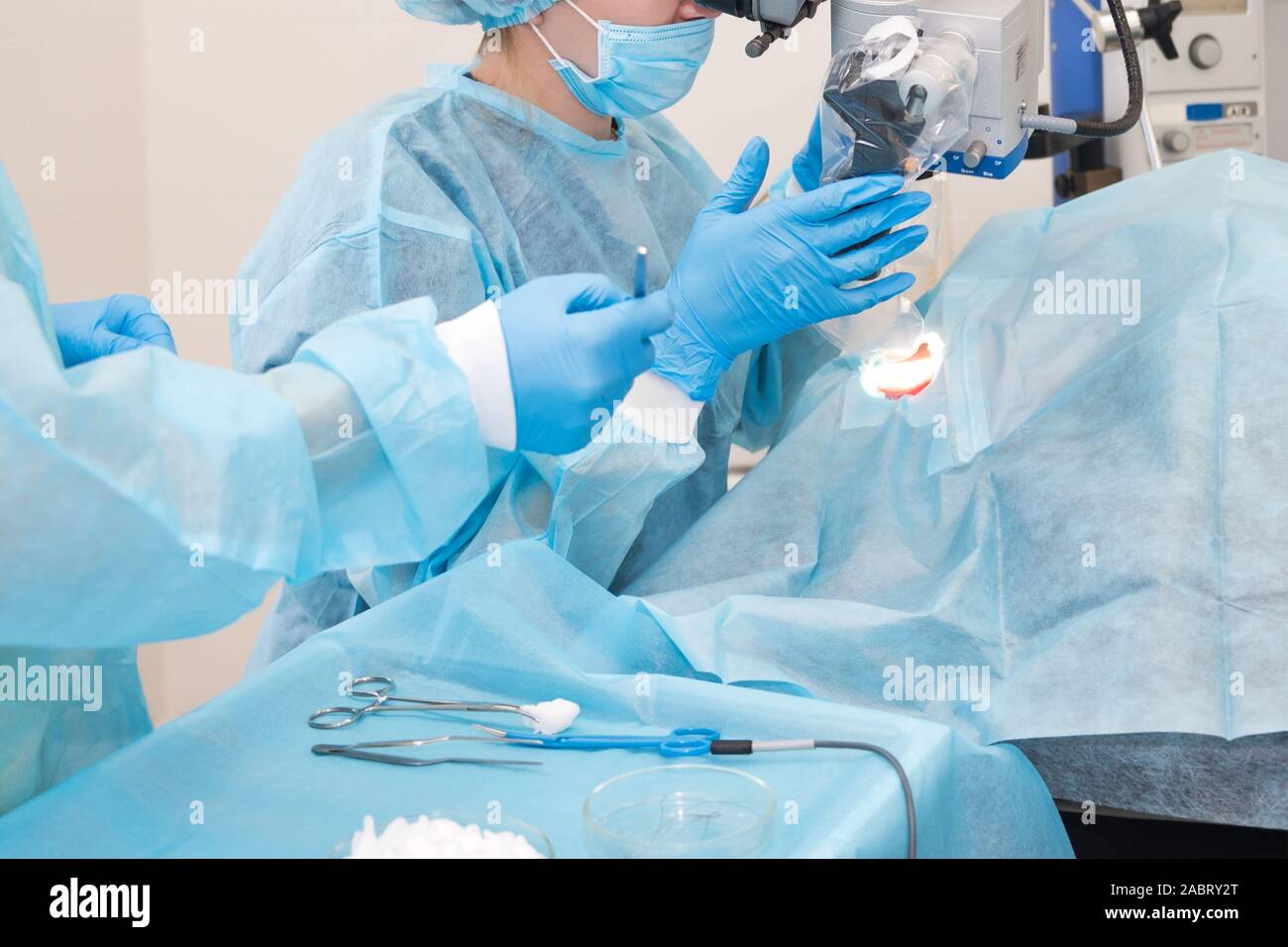 Nurse giving a tool to a doctor during surgery. Hands of doctors during hospital surgery. Ear surgery Stock Photo