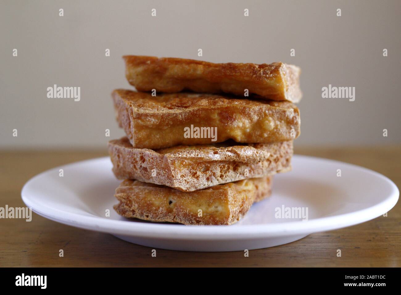 Photo of a stack of freshly fried tokwa or tofu or soy bean curd Stock