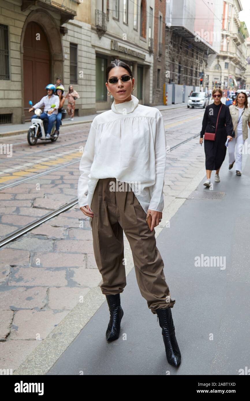 MILAN, ITALY - SEPTEMBER 18, 2019: Woman with white shirt and brown  trousers before Calcaterra fashion show, Milan Fashion Week street style  Stock Photo - Alamy