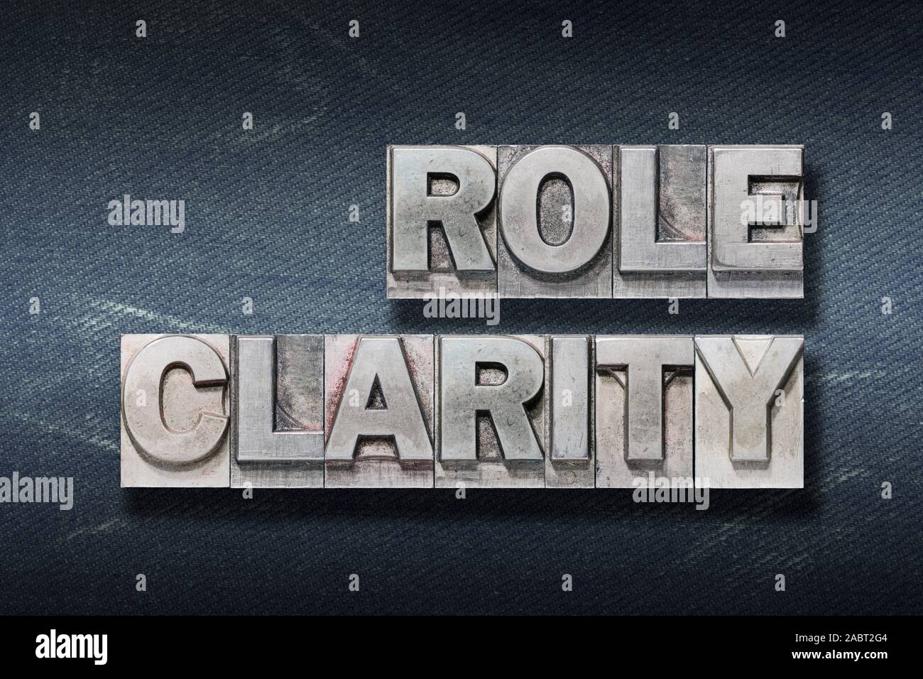 role clarity phrase made from metallic letterpress on dark jeans background Stock Photo