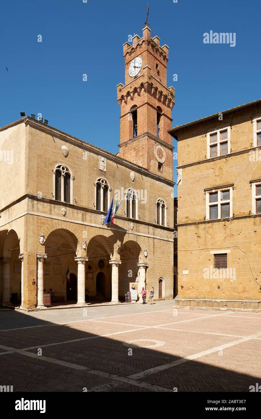 Loggia and bell tower of the Palazzo Comunale in the historic central piazza of the UNESCO hill town of Pienza, Tuscany, Italy Europe Stock Photo