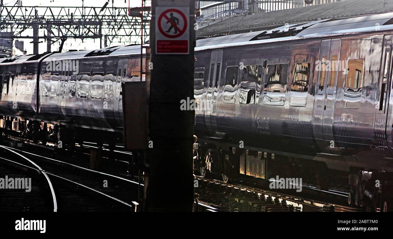 Reflections from a Class 380 Desiro coming to rest at Central Station.Glasgow Stock Photo