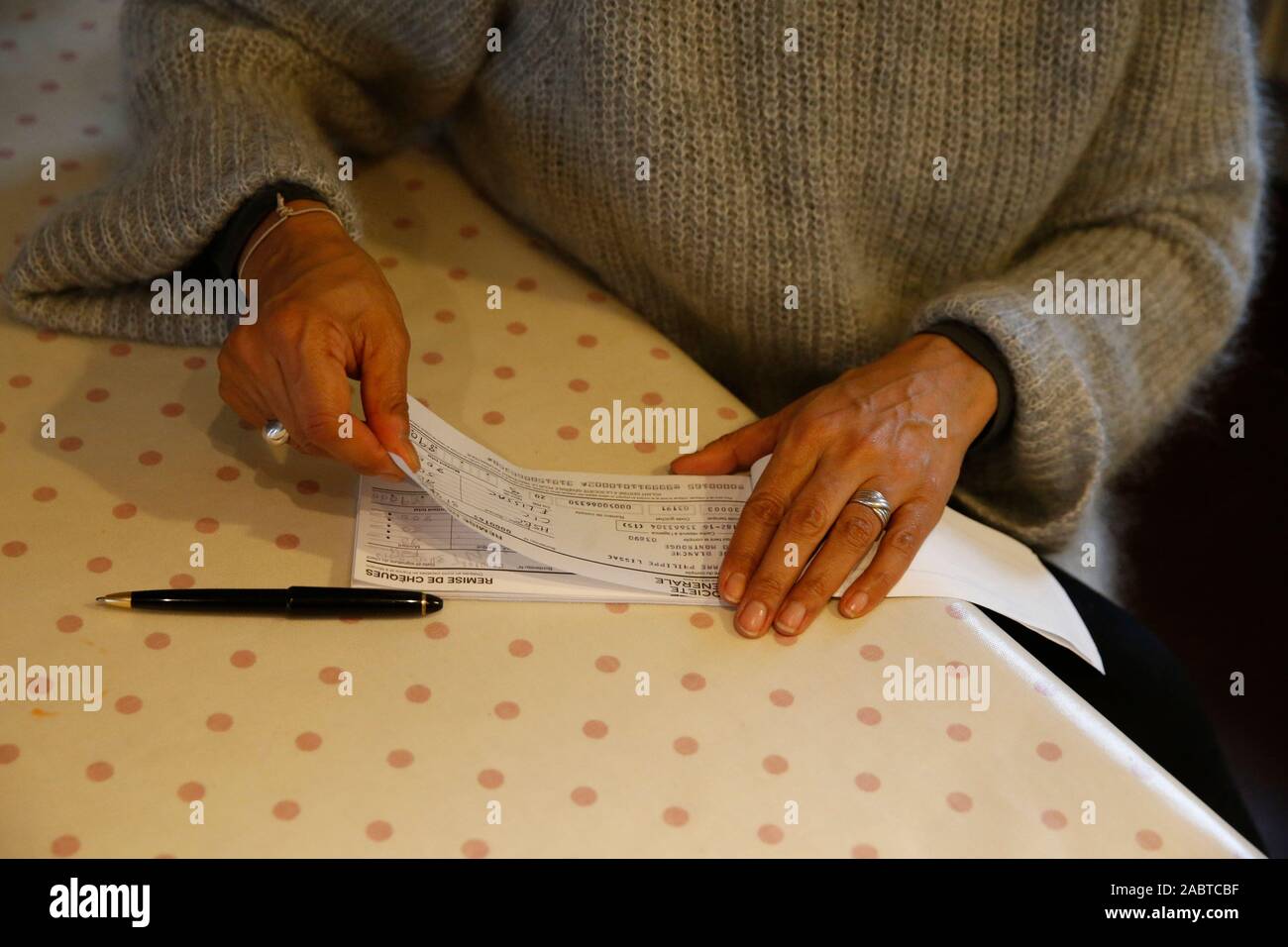 Woman writing a cheque in Montrouge, France Stock Photo Alamy