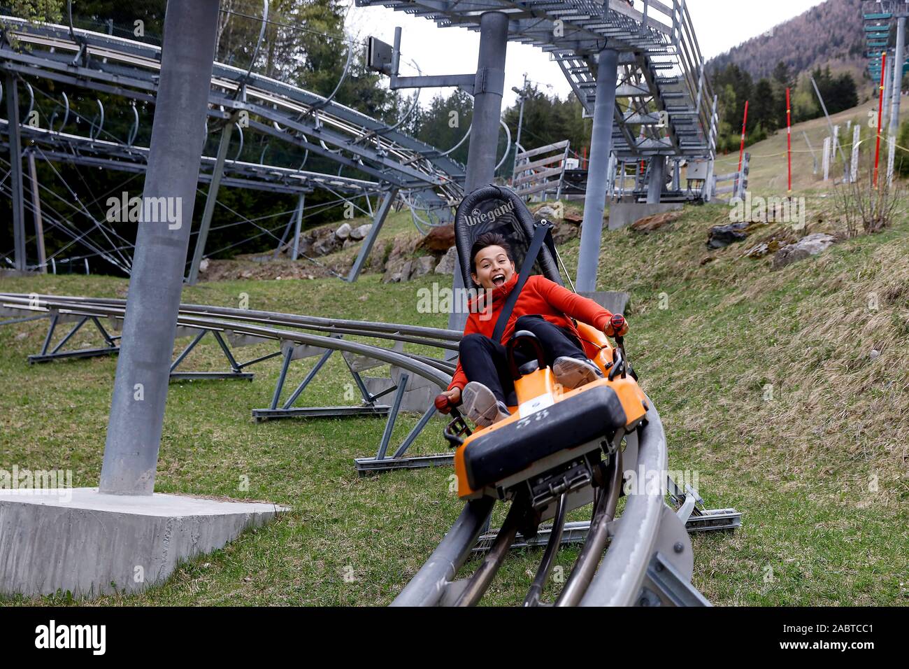 13-year-old boy riding an alpine coaster in Chamonix, France. Stock Photo