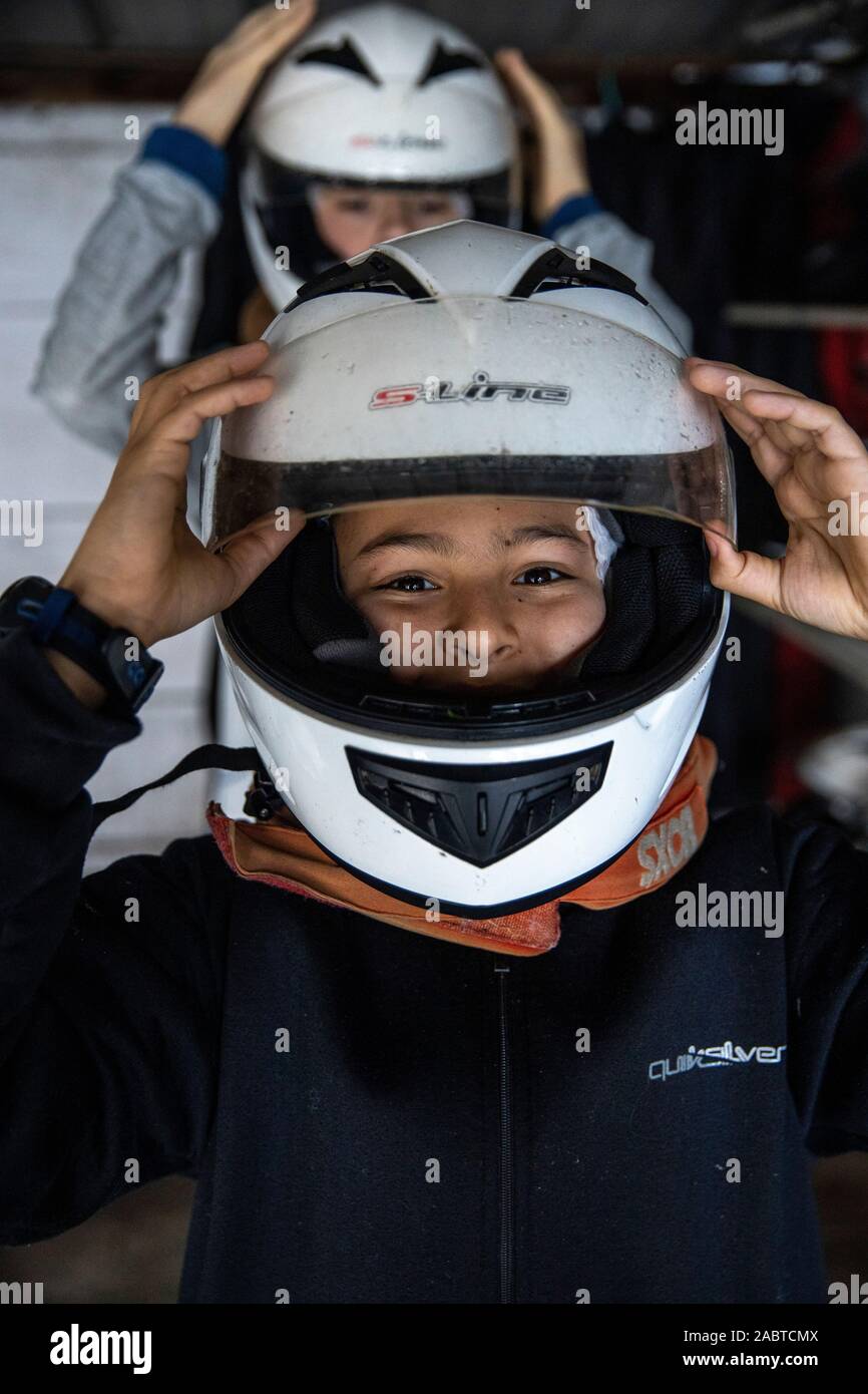 Teenager putting on helmets before riding go-karts. Cabourg, France