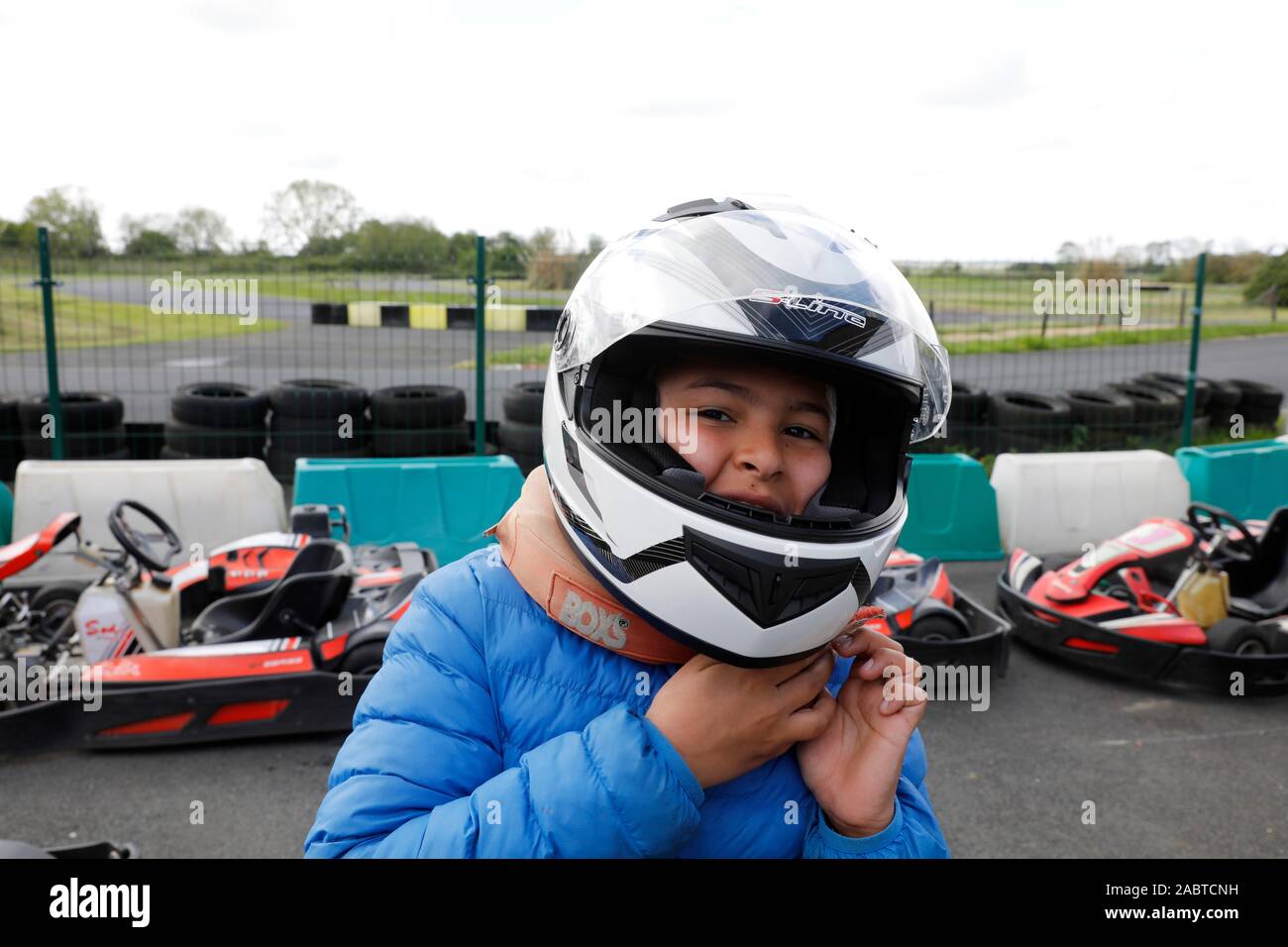 12-Year-Old Boy Taking Off A Helmet After Riding A Go-Kart In Cabourg, France Stock Photo - Alamy