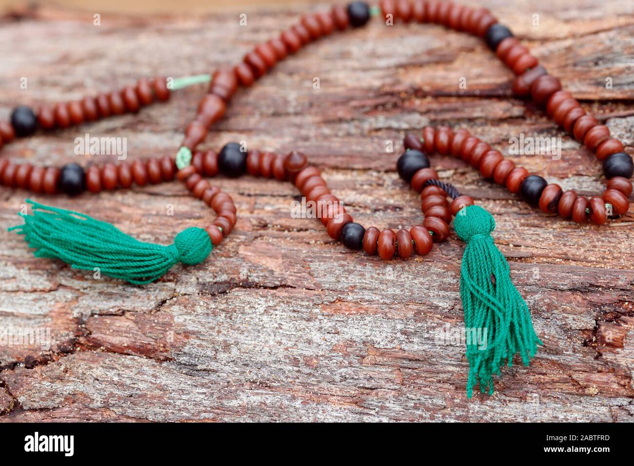 Muslim wooden prayer beads on a trunk. Stock Photo