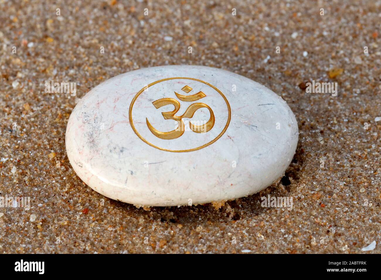 Stone On A Beach With The Om Or Aum Symbol Of Hinduism And Buddhism Stock Photo Alamy