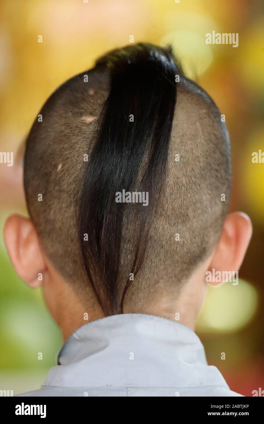 Young buddhist monk living in a buddhist temple.  The tonsure is a sign of religious devotion or humility. Vietnam. Stock Photo