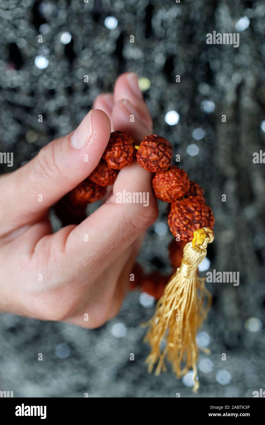 A woman praying Mala beads, the Buddhist prayer beads. Close-up